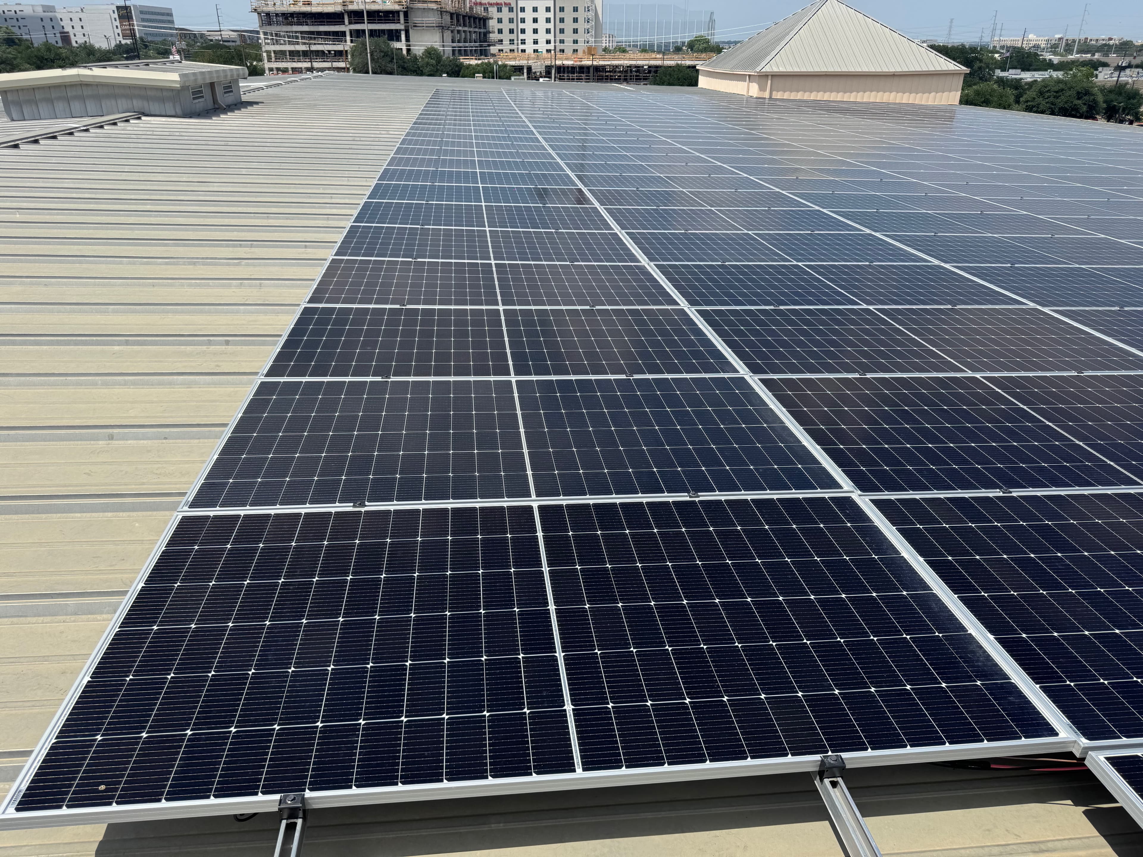 Real commercial metal-roof solar array documented on an active jobsite