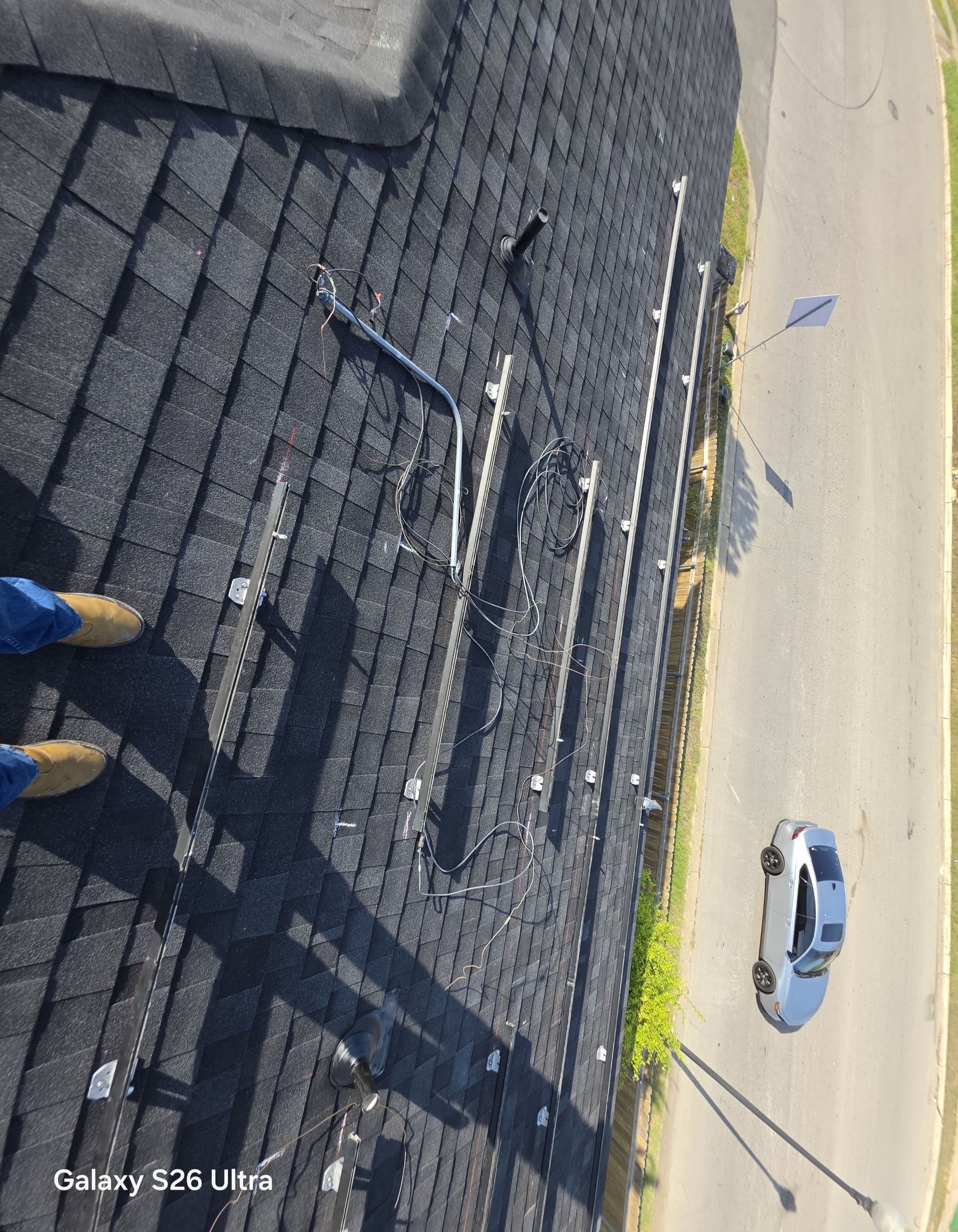 Field photo of rails, open wiring, and conduit during detach/reset work